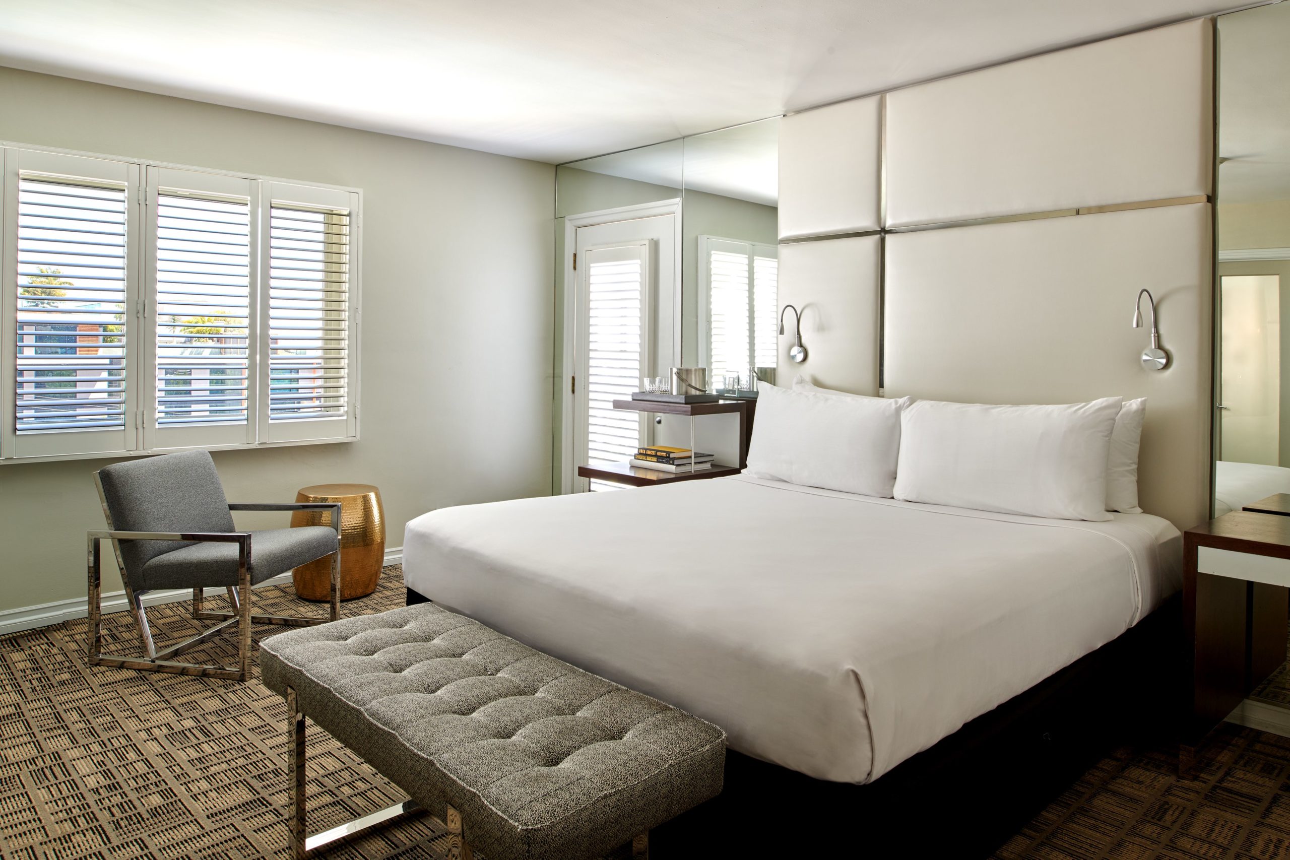 Bedroom with white wall and a mirror