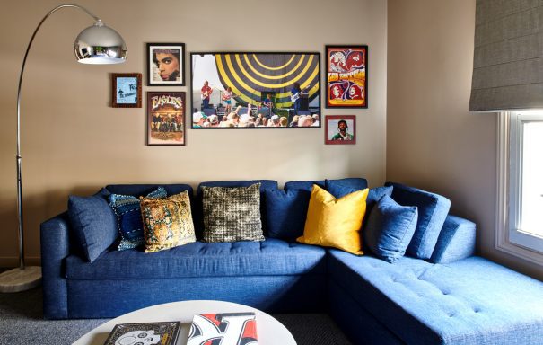 Guest room sectional sofa with wall artwork and coffee table