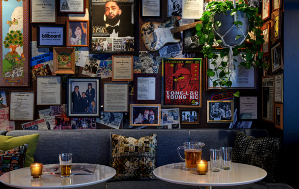 Glasses of beer on the two tables with the various picture frames on the wall